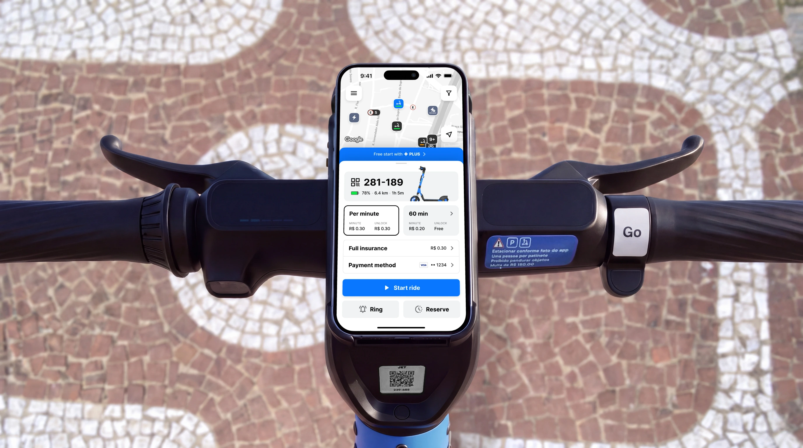 The JET app on a phone mounted on a scooter’s handlebar, over a Copacabana-style mosaic pavement